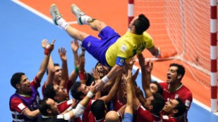 Iran's team players throw in the air Brazilian player Falcao as they celebrate their victory over Brazil at the FIFA Futsal World Cup 2016 in Colombia (Photo by Guillermo Legaria - AFP)